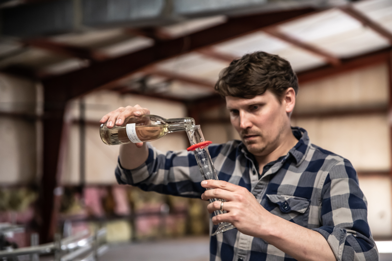 image of the head wine maker at the obc wine project evaluating the chemistry of winemaking