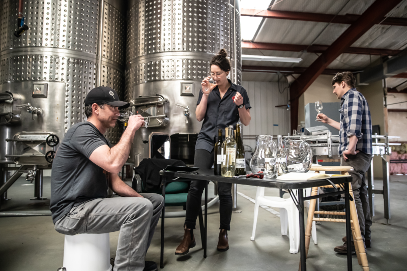 image of odell wine project wine makers tasting wine in the odell wine project production facility